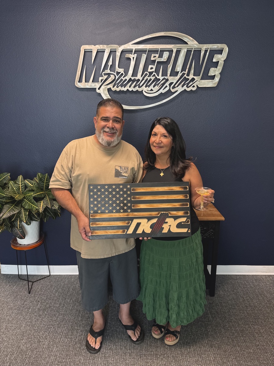 NCRC representatives holding an NCRC plaque at Masterline Plumbing