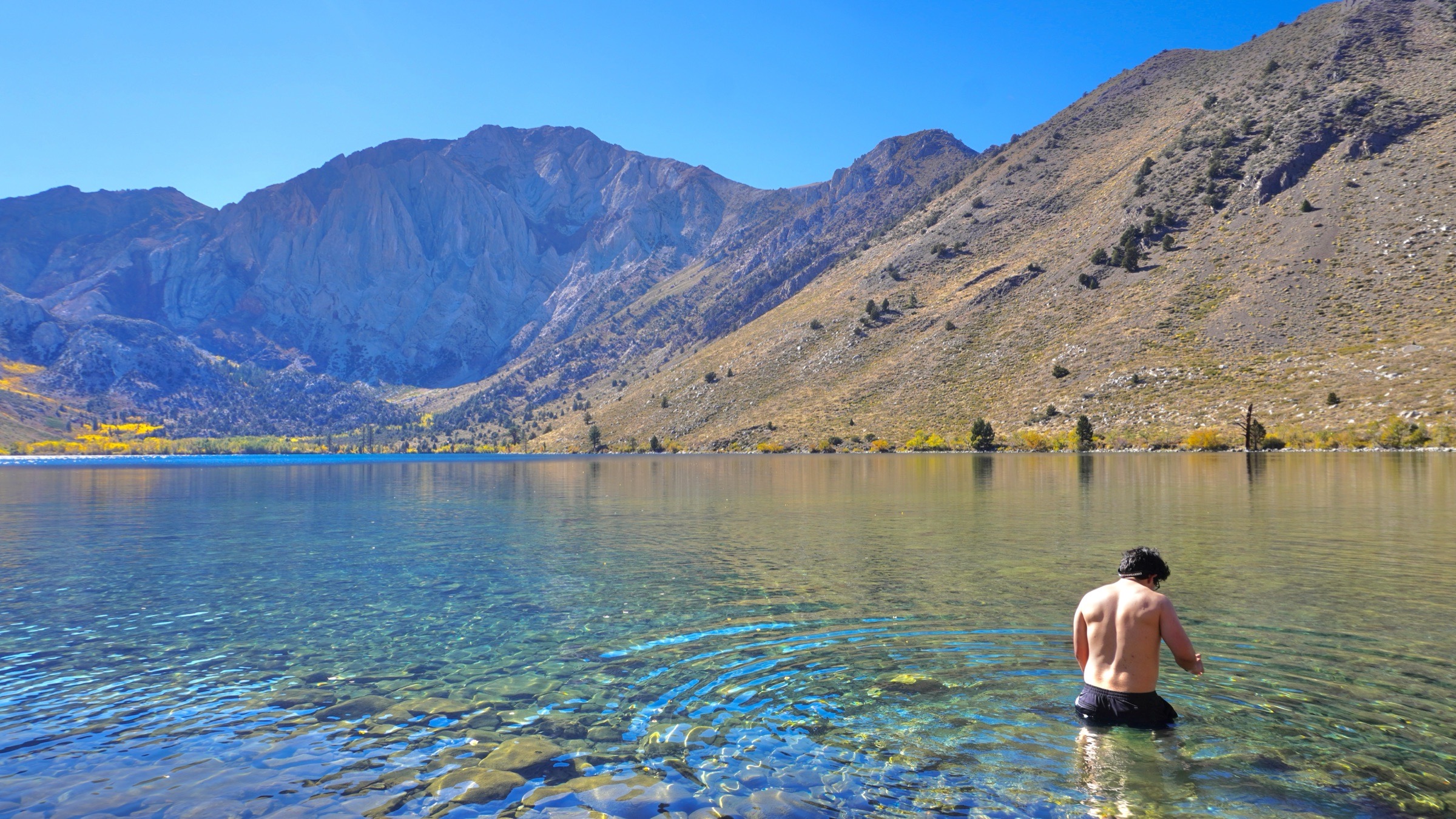 Tim Yslava carefully entering the cold, clear water at Convict Lake