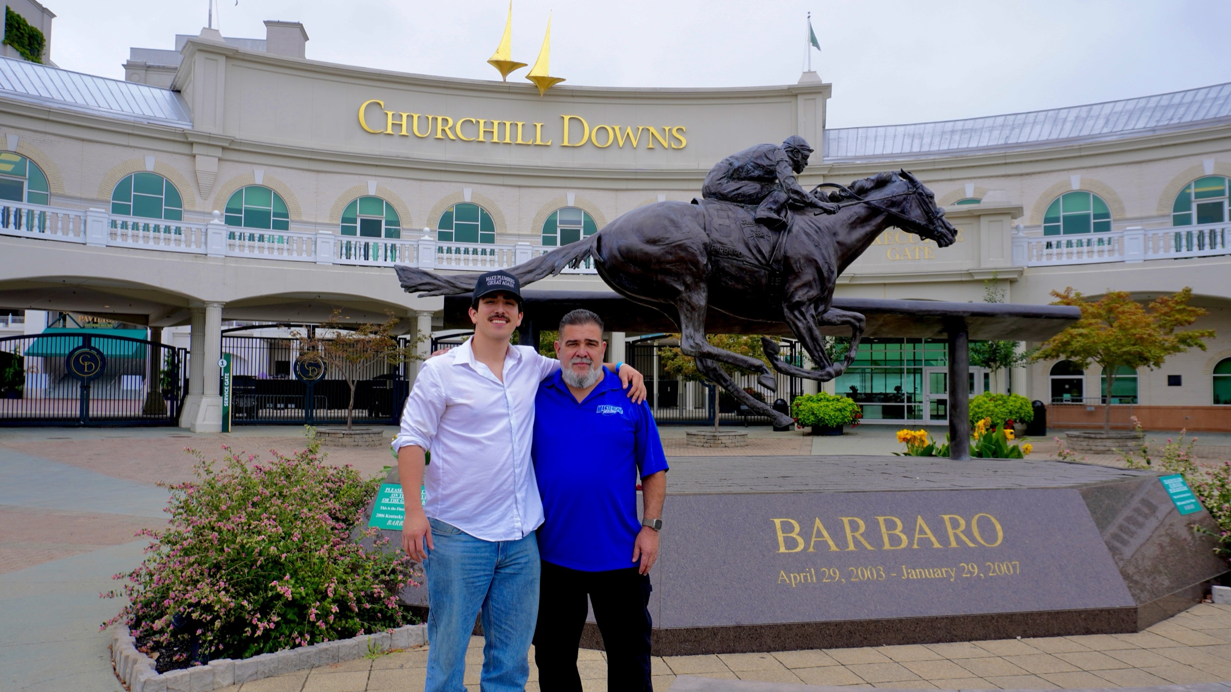 Tim Yslava and his father standing in front of the Barbaro statue at Churchill Downs