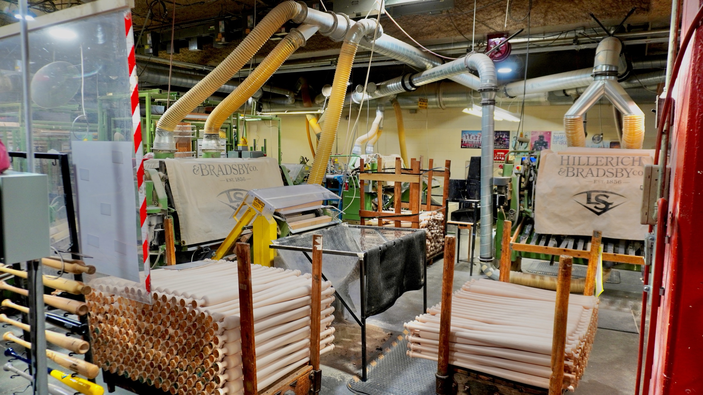 Wooden baseball bats moving through the production floor at the Louisville Slugger factory